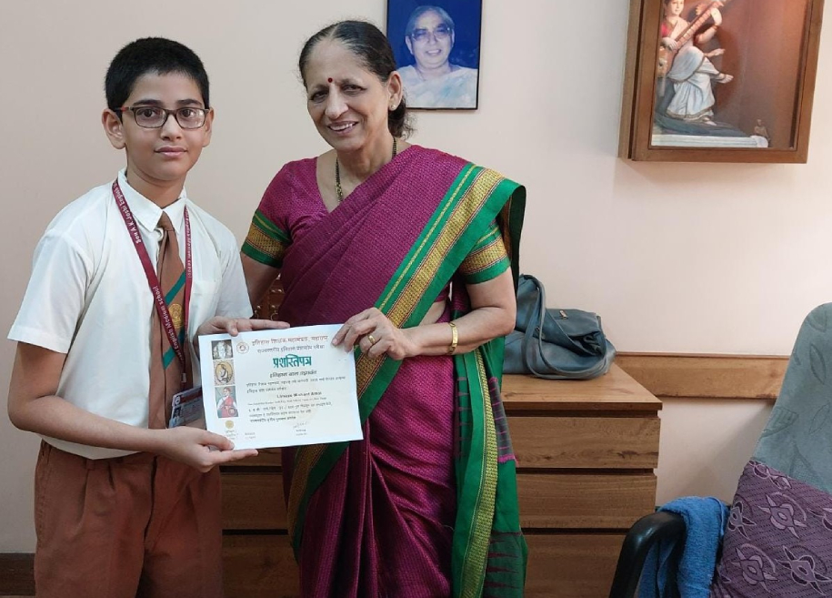 Students proudly displaying their awards and certificates for their outstanding achievements in various competitions and examinations at AK Joshi CBSE School in Thane, representing excellence and success.