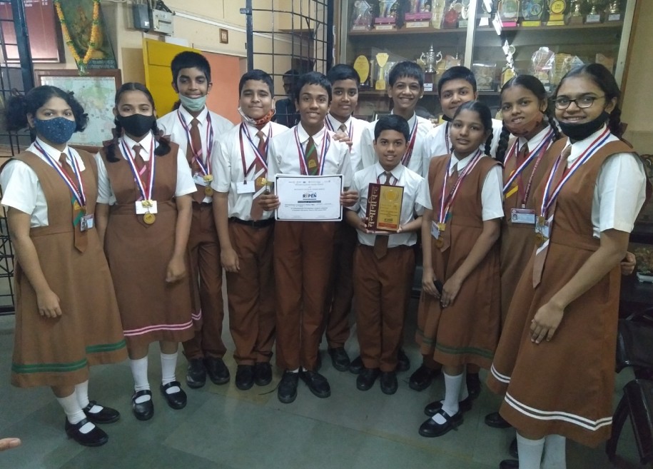 Students proudly displaying their awards and certificates for their outstanding achievements in various competitions and examinations at AK Joshi CBSE School in Thane, representing excellence and success.